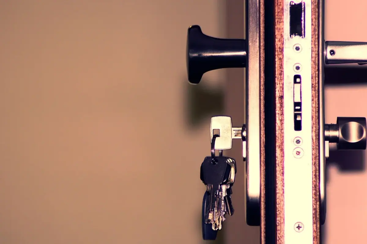 Licensed locksmith technician at a Newport Beach home front door with keys